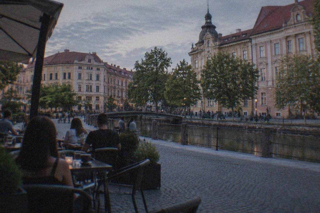 A café terrace on a pedestrian square in Timisoara with people seated at outdoor tables