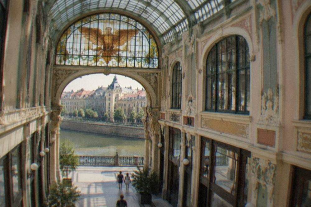 A glass-roofed Art Nouveau arcade passage with a stained glass eagle window in Oradea, Romania