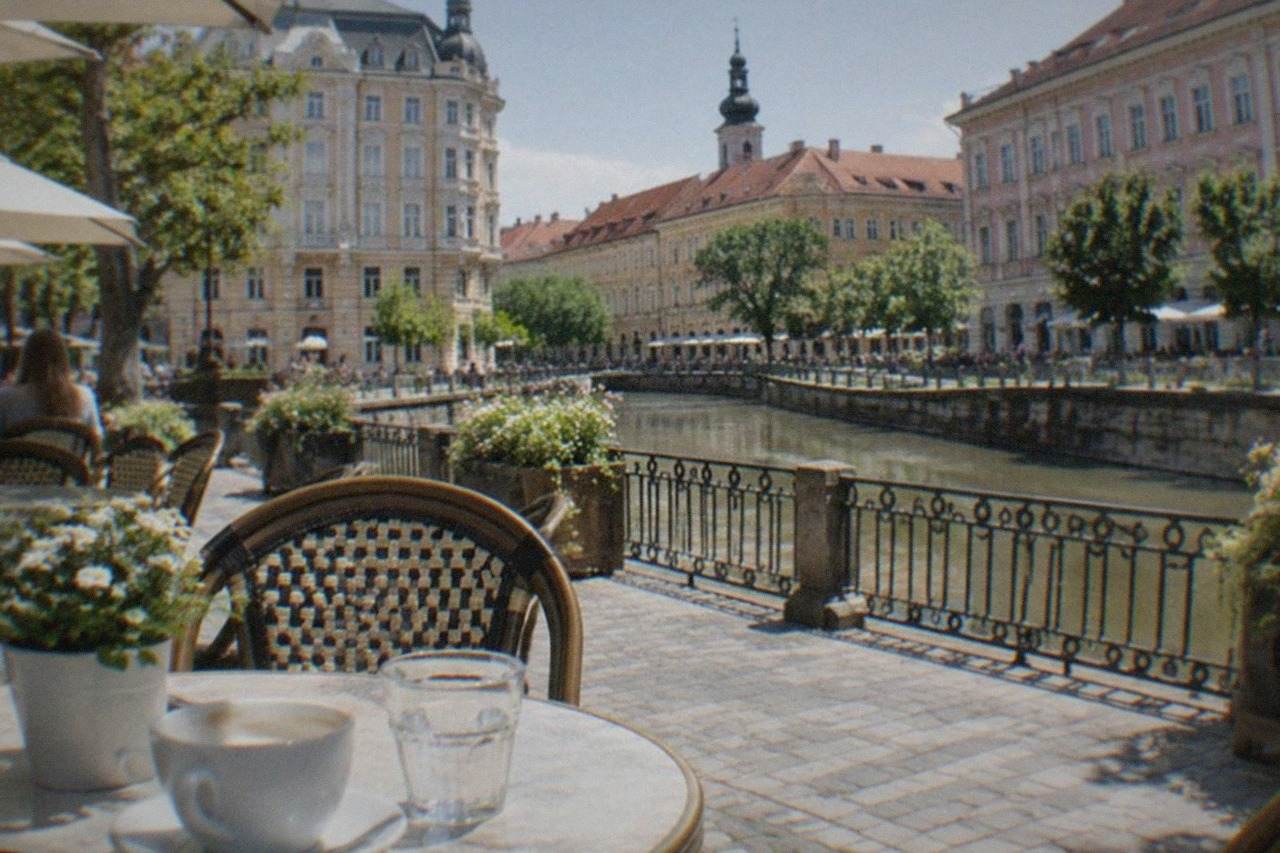 Outdoor cafe tables on a sunny square in Timisoara with coffee cups and a restaurant menu visible