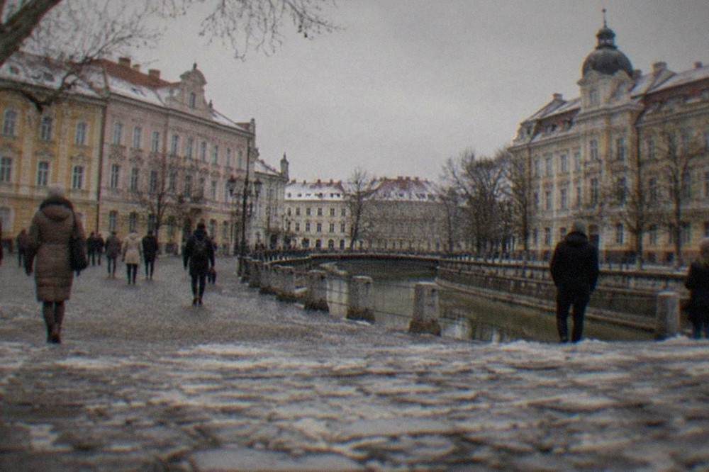 Visitors walking across a historic city square in Timisoara on a gray winter day