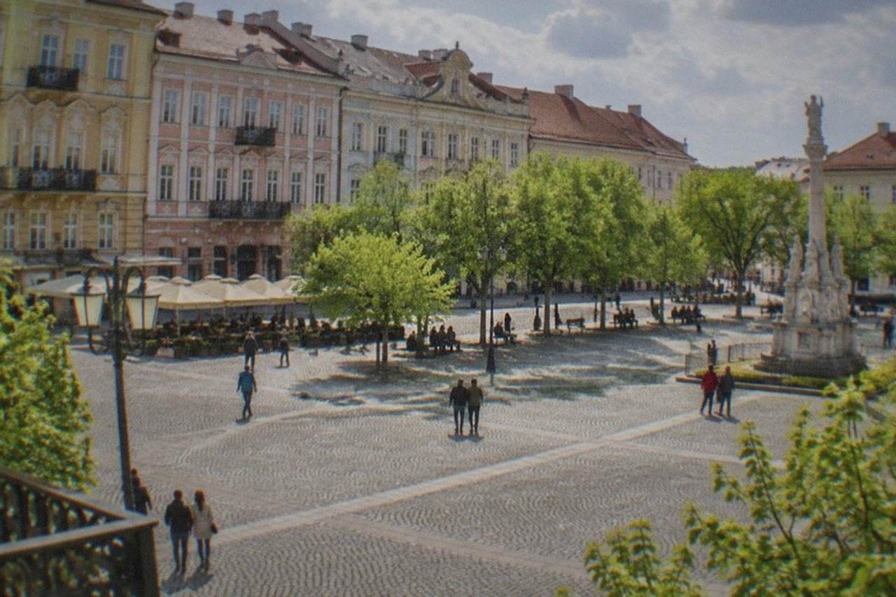 Union Square in Timisoara on a sunny spring day, pastel baroque buildings around the plaza
