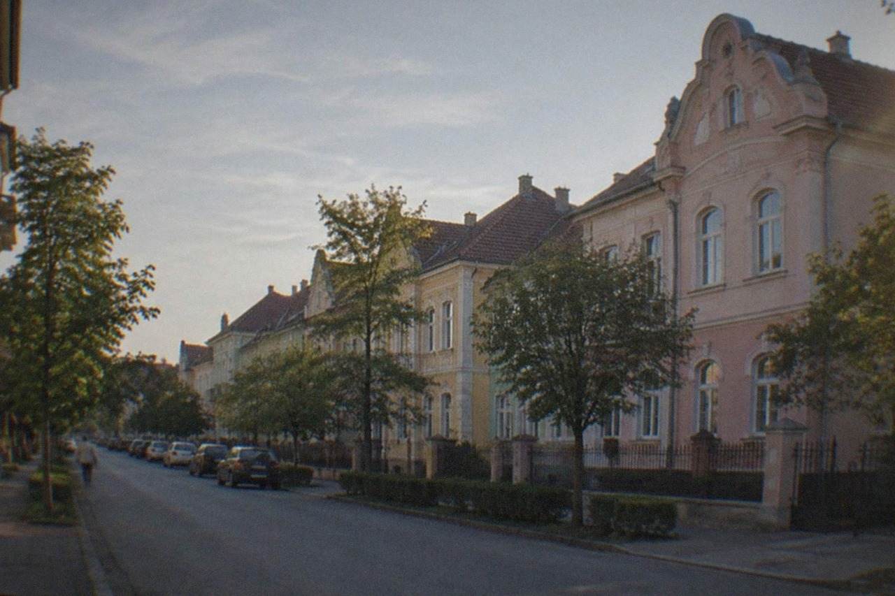 Pastel-colored historic buildings on a quiet street in the Iosefin district of Timisoara