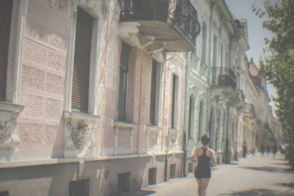 A restored Secession facade with ornamental detailing on a residential street in Iosefin