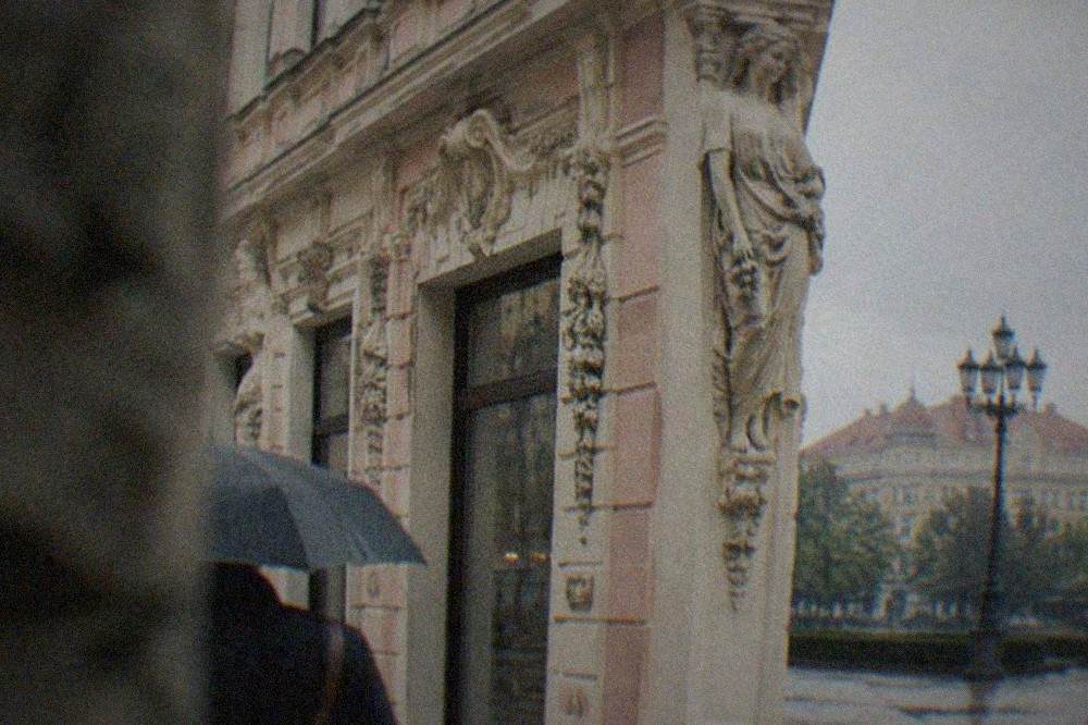 Close view of carved figures and floral ornament on an old building wall