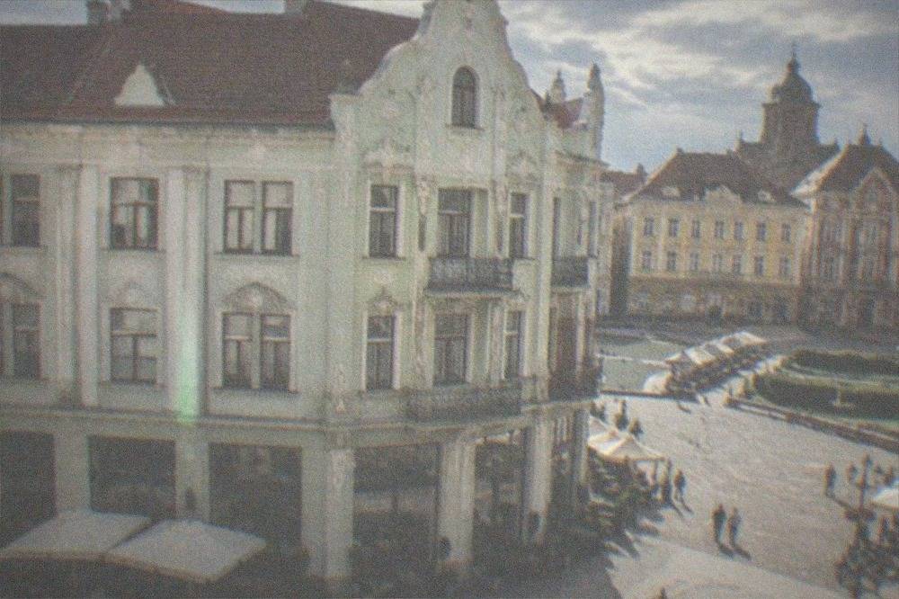 Colorful baroque buildings and cafe terraces around a historic square