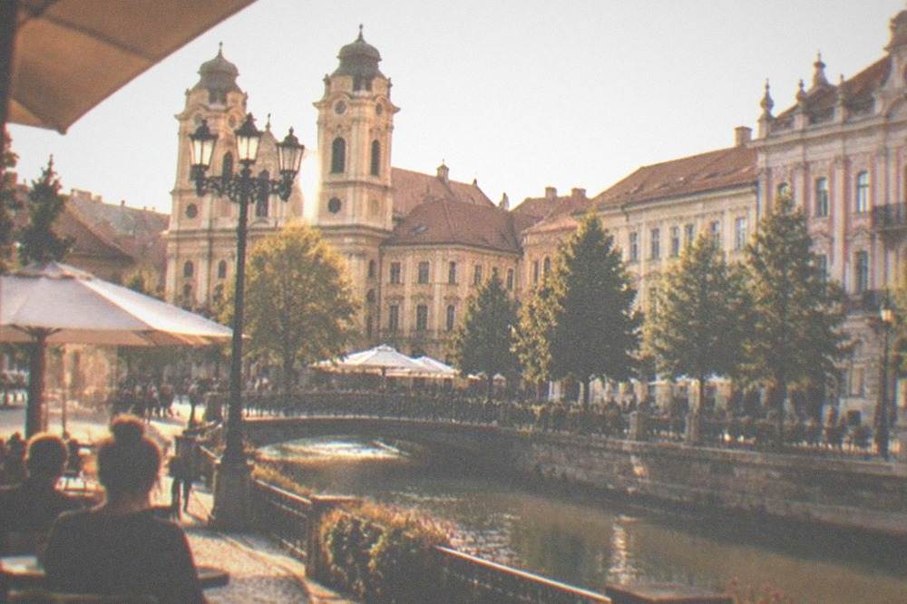 Baroque buildings and cafe terraces around a city square in Timisoara