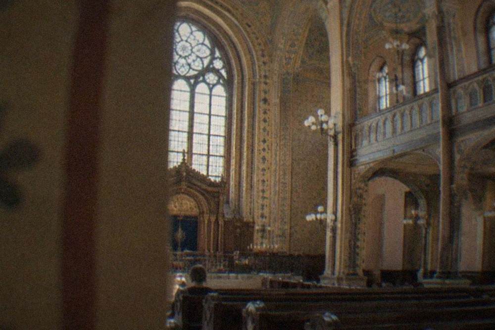 Interior of a restored synagogue with painted stenciled decoration on walls and ceiling