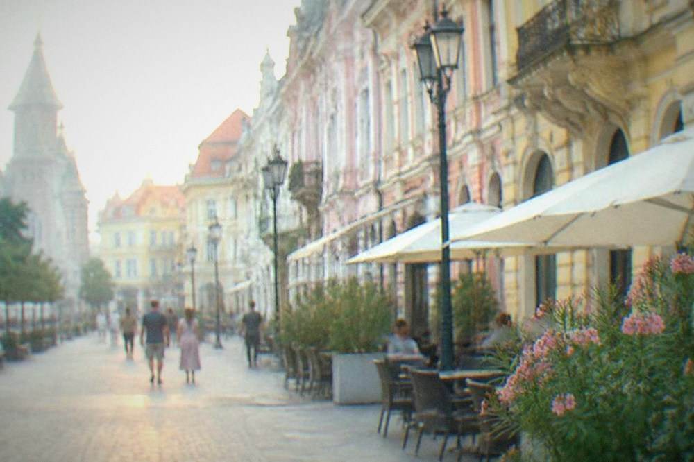 Pedestrian street in Timisoara old town with colorful baroque buildings under evening light