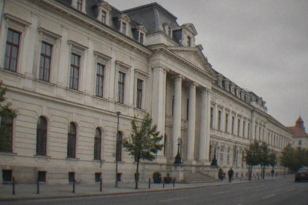 Close view of the palace facade showing rows of tall windows, pilasters and roof dormers