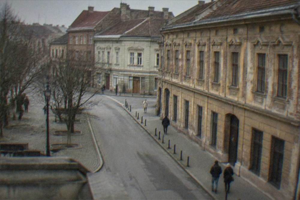 Visitors walking past heritage facades on a quiet street in the Fabric district