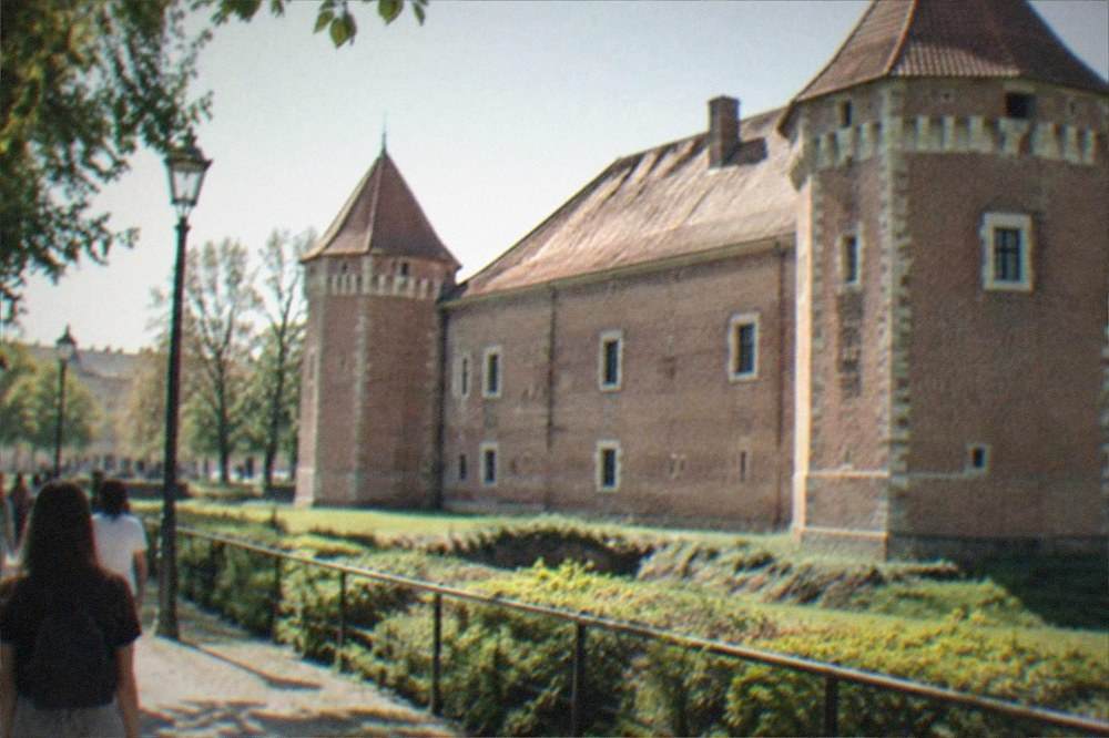 Visitors walking the path between the castle park and the city center