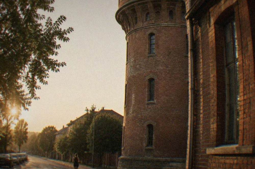 Close view of the brick walls and narrow windows of an old industrial water tower
