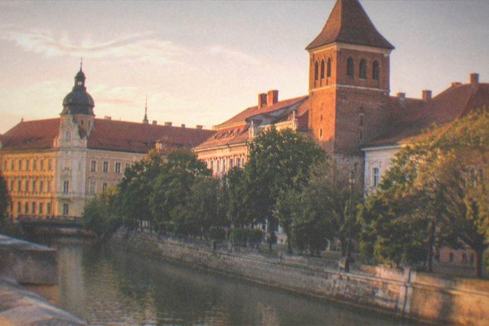 Sunset light on a brick tower and rooftops in a quiet district of Timisoara