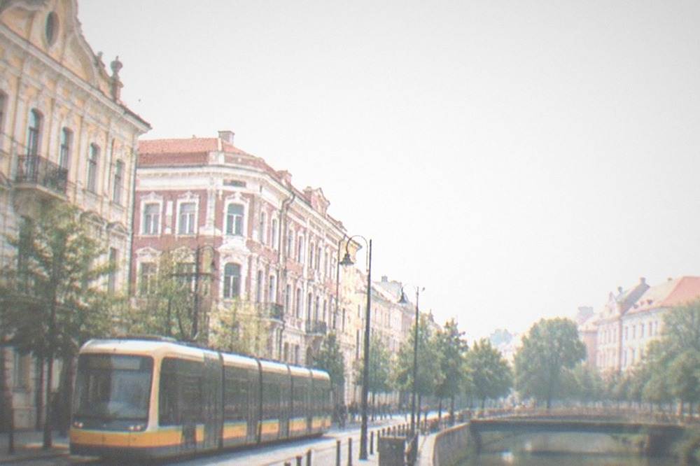 A modern tram passing historic buildings on a Timisoara street