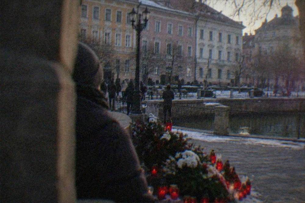 Candles and flowers at a December commemoration in a Timisoara square