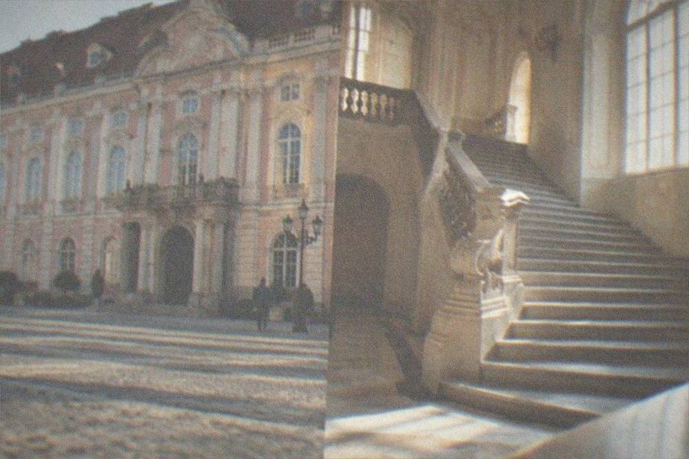 A grand interior staircase with baroque detailing inside the palace museum