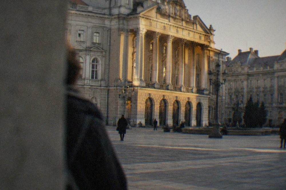 Evening light on the Opera building's columns and balconies above the square