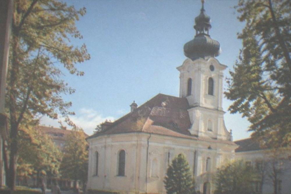 Church dome and rooftops under a clear blue sky in early autumn