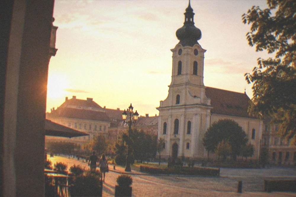 Wide view of a historic Central European city square at golden hour
