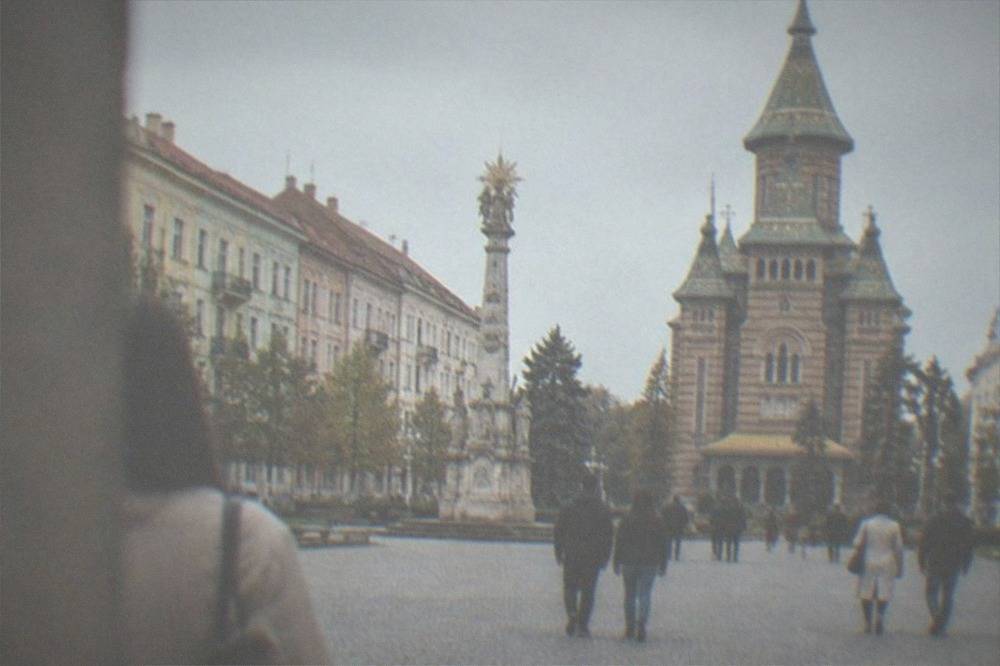 Visitors walking across Union Square toward the cathedral entrance in Timisoara