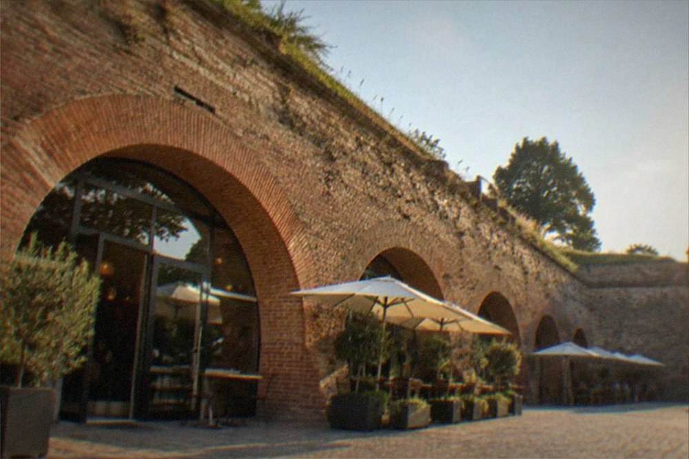 The brick arches and old stone of the bastion walls lit in the evening
