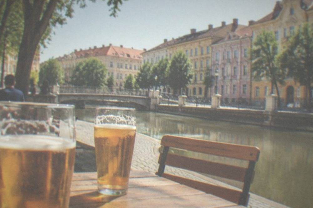 Outdoor terrace tables with beer glasses on a sunny square in Timisoara
