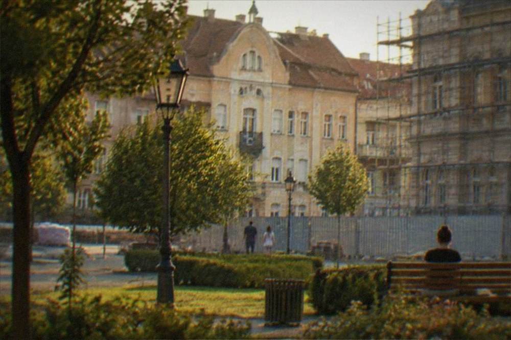 Construction fencing and scaffolding around a historic square being renovated