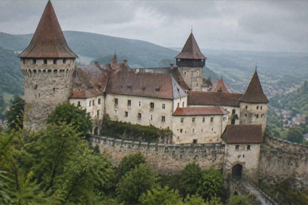 A panoramic view over a Transylvanian castle with towers and restored walls
