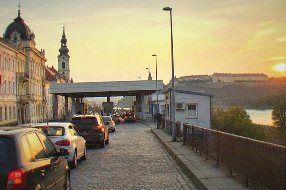 Cars queuing at a small road border crossing between Romania and Serbia