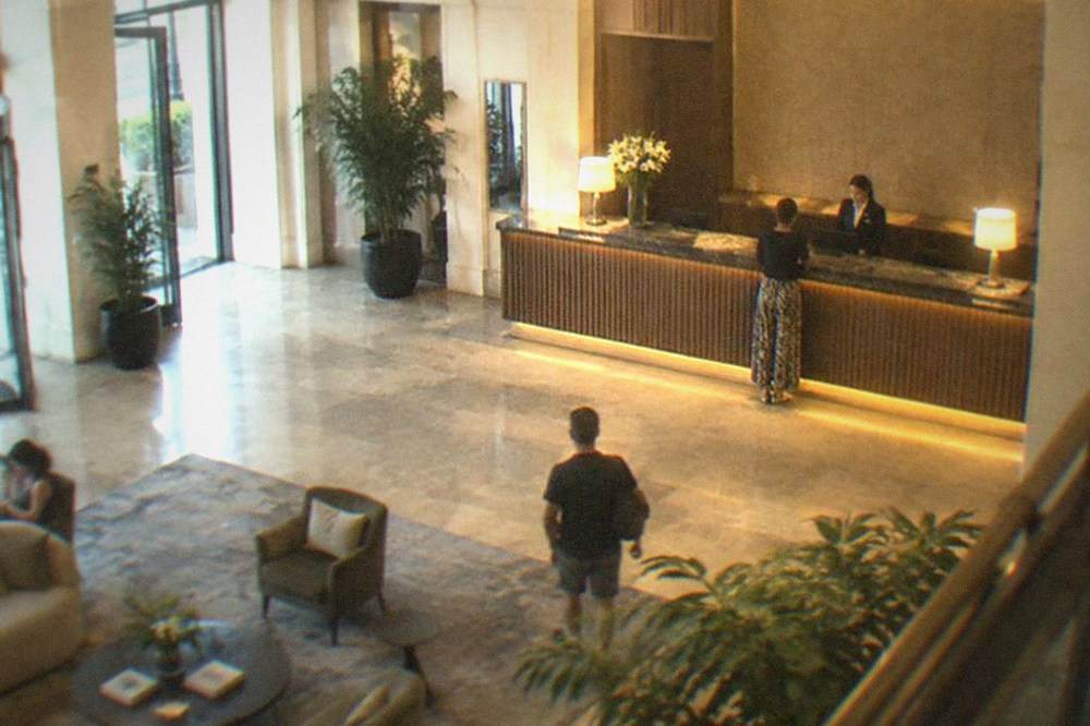 A modern hotel lobby with warm lighting and a reception desk in Timisoara