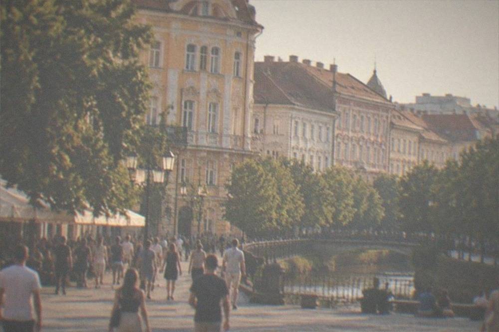 Crowds of visitors walking across a central square in Timisoara on a summer evening