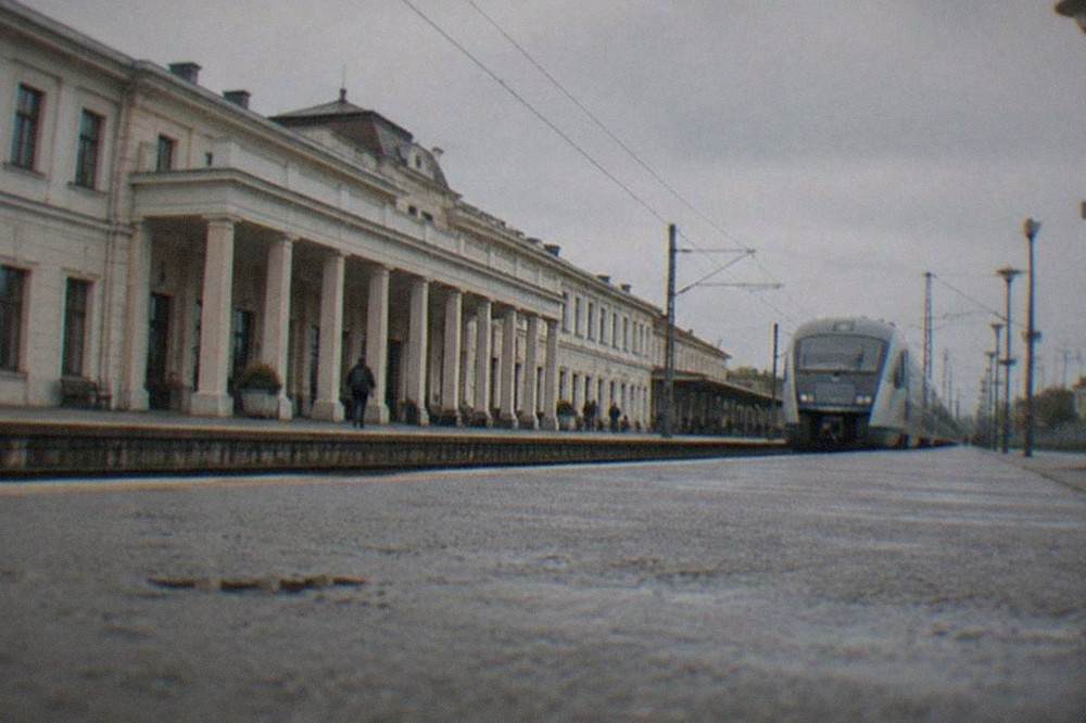 A modern interregional train waiting at a Romanian railway station platform