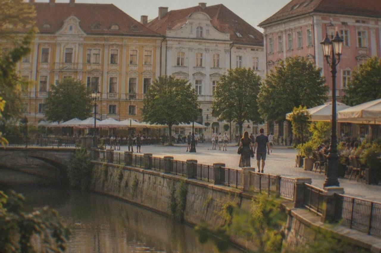 Colorful baroque buildings and café terraces around a wide pedestrian square in Timisoara on a sunny afternoon