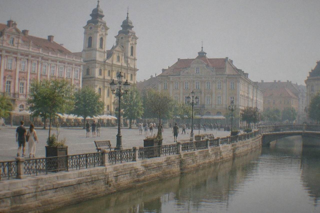 A wide view of a colorful square in Timisoara with baroque buildings and people walking