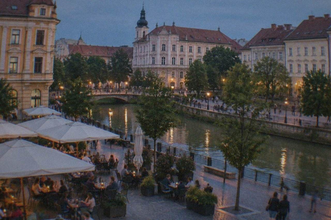 A cafe terrace on a pedestrian square in Timisoara with people talking at outdoor tables