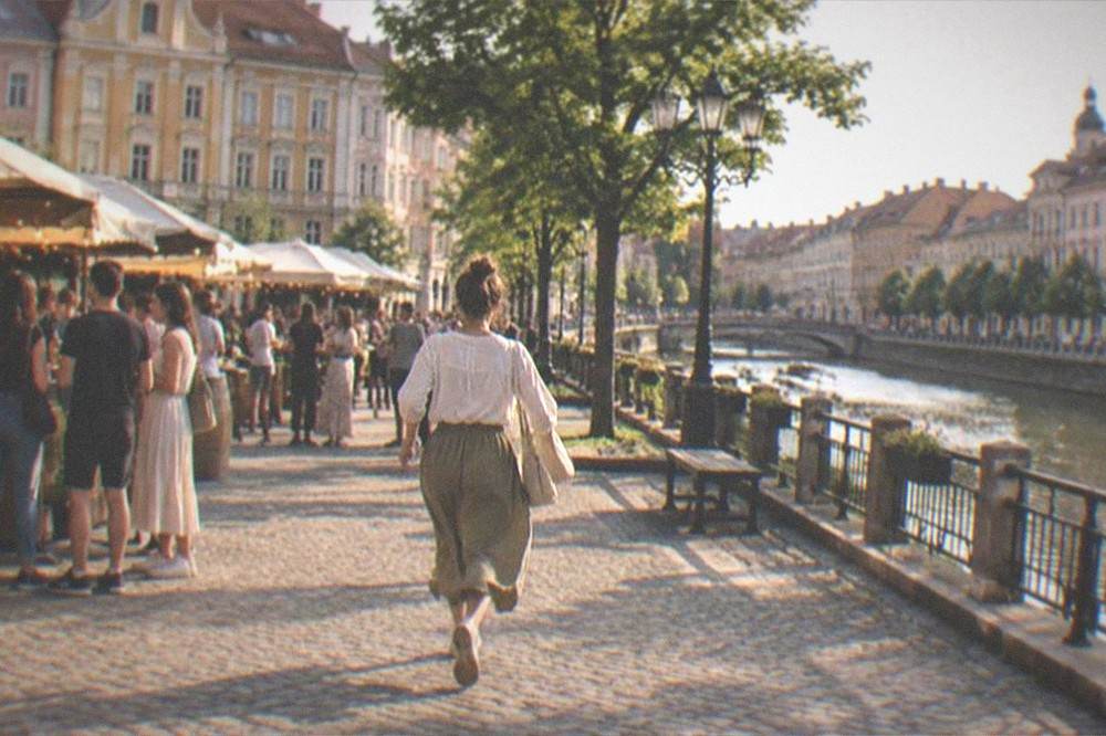 People chatting at an evening market stall on a square in Timisoara