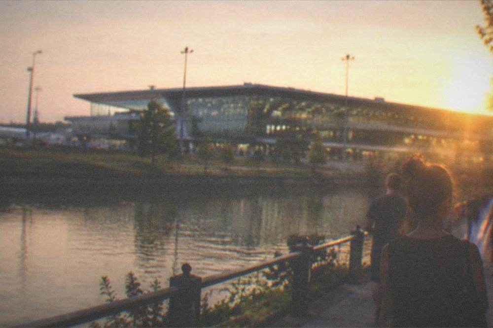 People strolling along a canal promenade in the evening