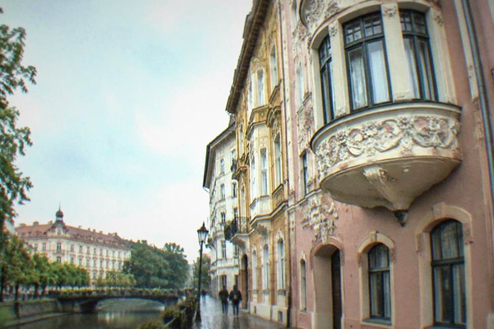 An Art Nouveau facade with floral stucco ornament and a curved bay window in Timisoara