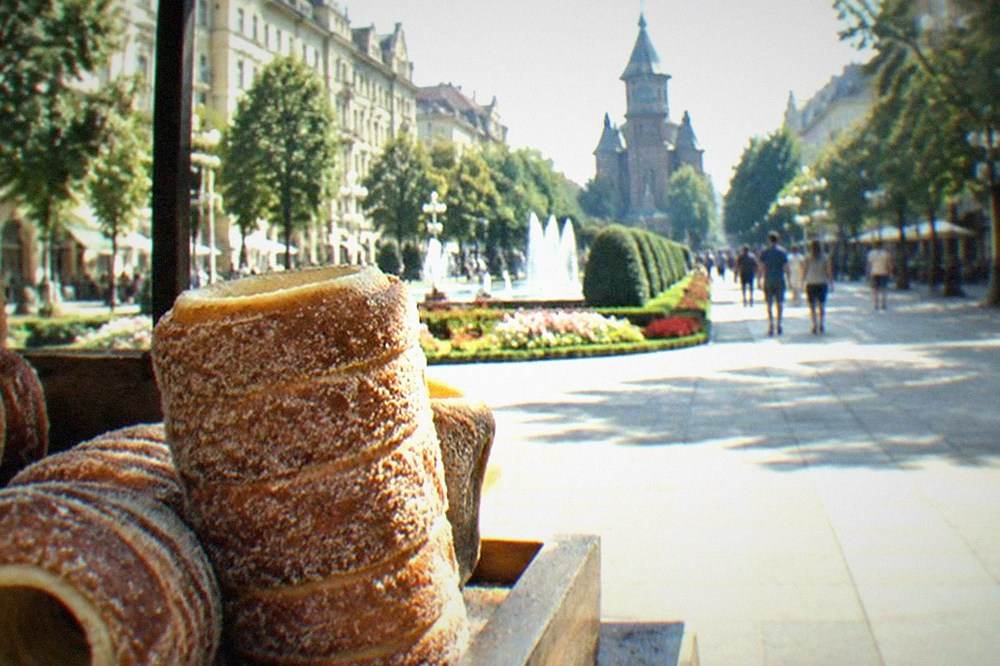 Close-up of a chimney cake pastry coated in sugar on a market stall