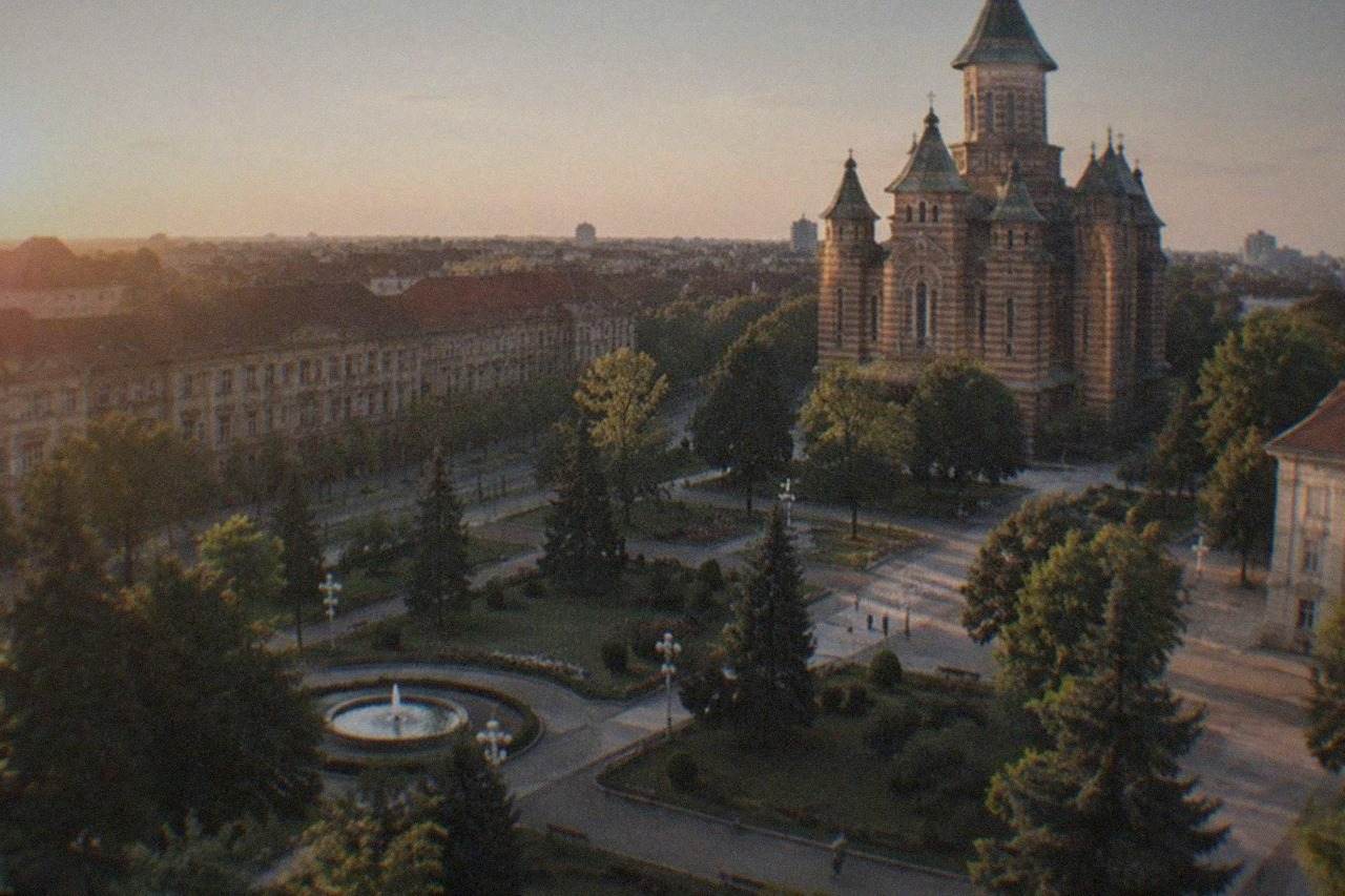 Domes and towers of the Orthodox Metropolitan Cathedral rising above a Timisoara square at golden hour