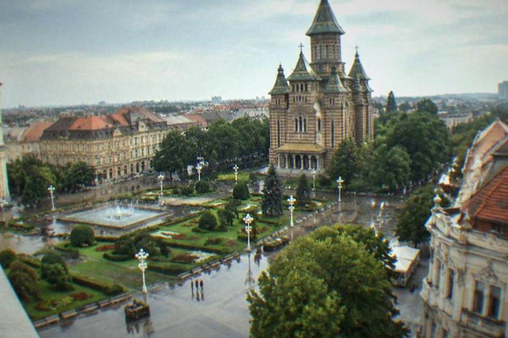 Towers of two historic cathedrals seen from opposite corners of a baroque city square