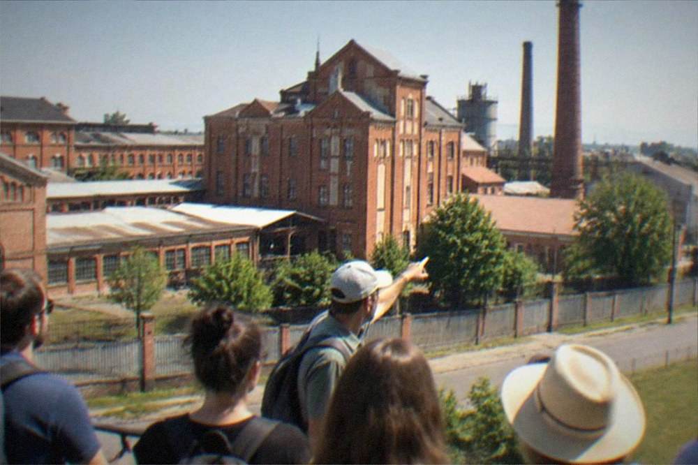 Guide pointing out buildings to a small group on a city walking tour