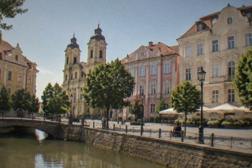 Restored baroque facades and colored buildings around a square in Timisoara