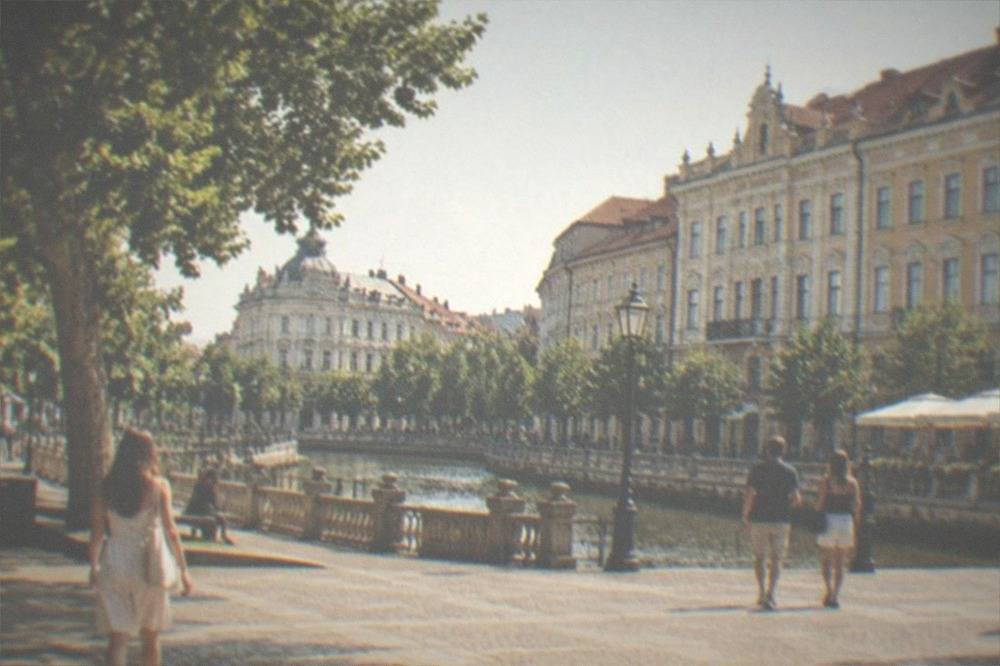 People walking across a lively square in central Timisoara on a summer evening
