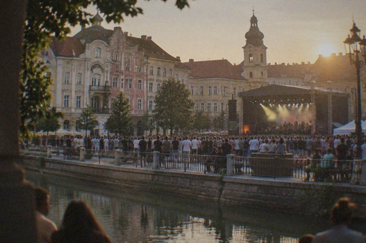 Crowds gathered in a lit square in Timisoara during an evening festival concert