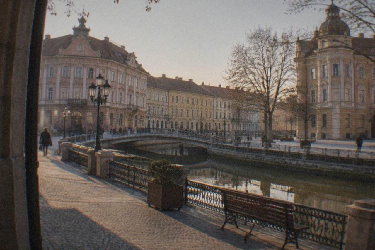 Pastel-colored baroque buildings around a wide square in Timisoara at golden hour