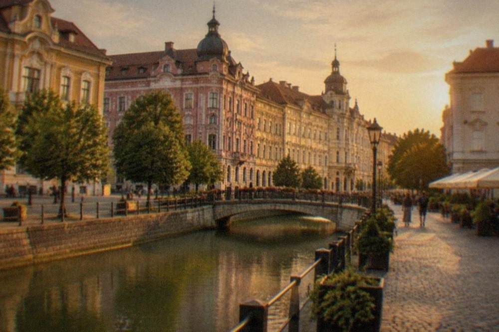 Colorful baroque buildings around a cobblestone square in Timisoara at golden hour