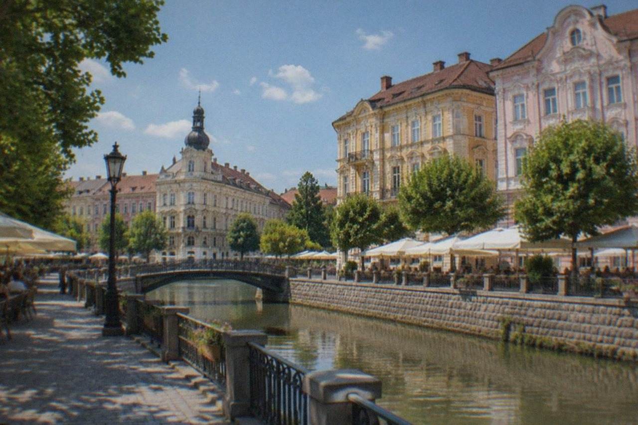 Sunlit baroque facades and cafe terraces around a square in Timisoara on a warm summer afternoon