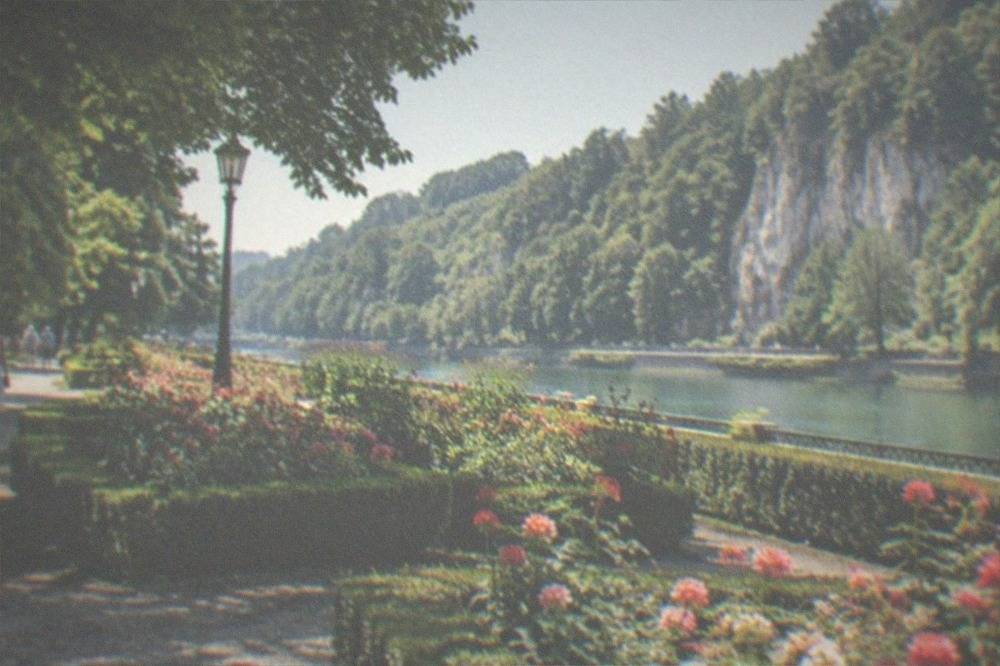 Turquoise water pooling beneath forested limestone cliffs in a Banat gorge in summer