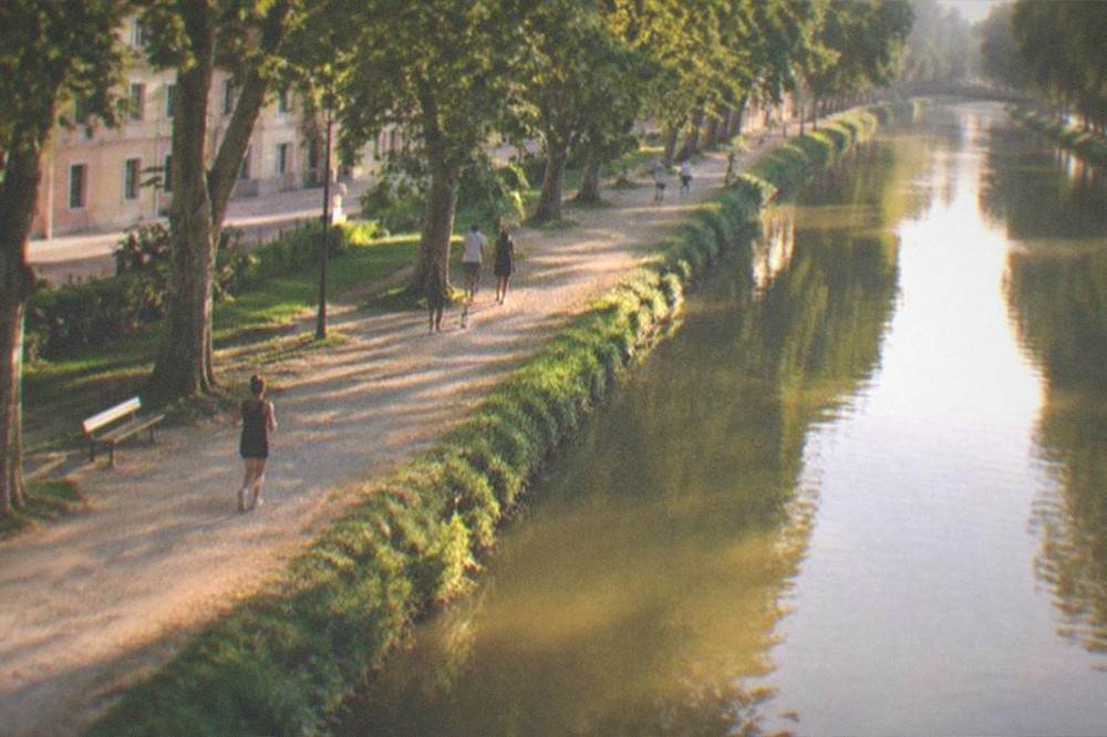 Golden evening light on the river and promenade along the Bega canal in Timisoara